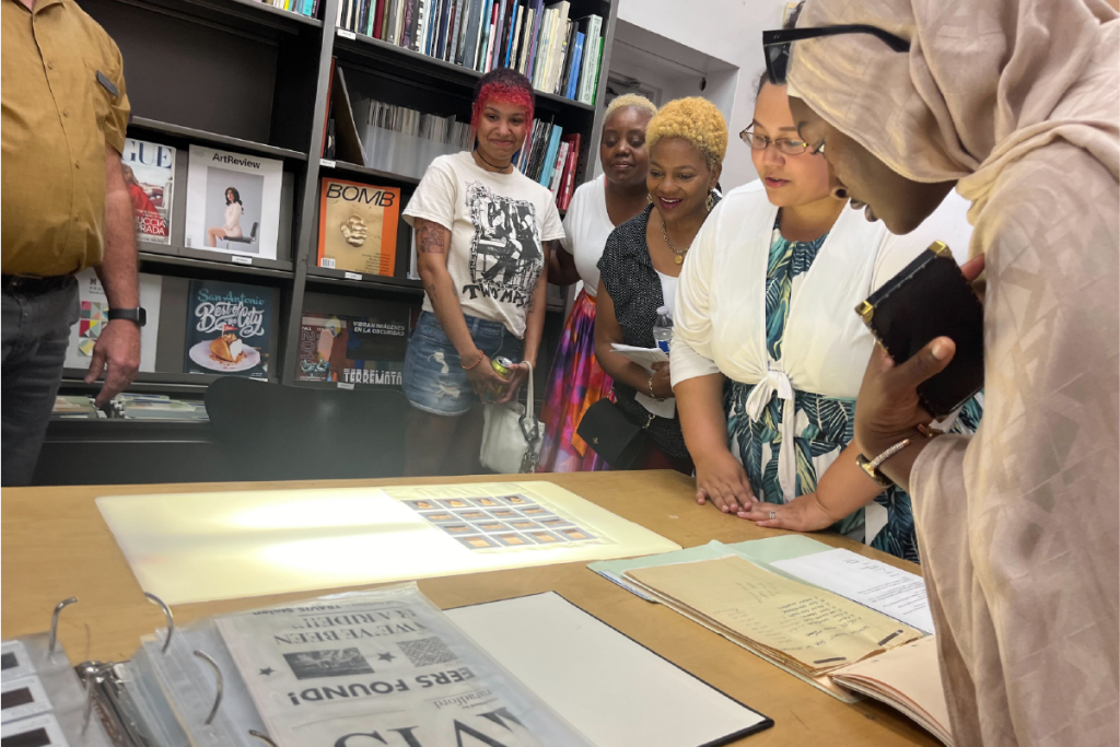 SAAACAM team members with Riley Robinson of Artpace, exploring their archive.